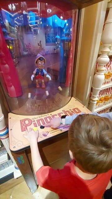 Hidden in Disneyland is this Pinocchio game. Wuld you play for a quarter?